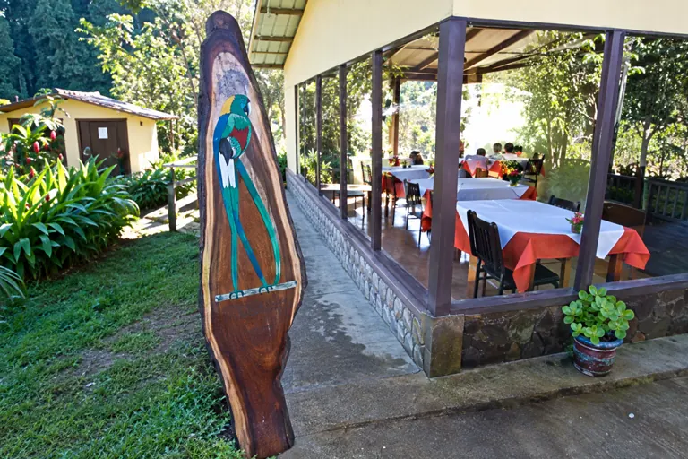 The open dining room and wooden quetzal sign at Miriam's restaurant